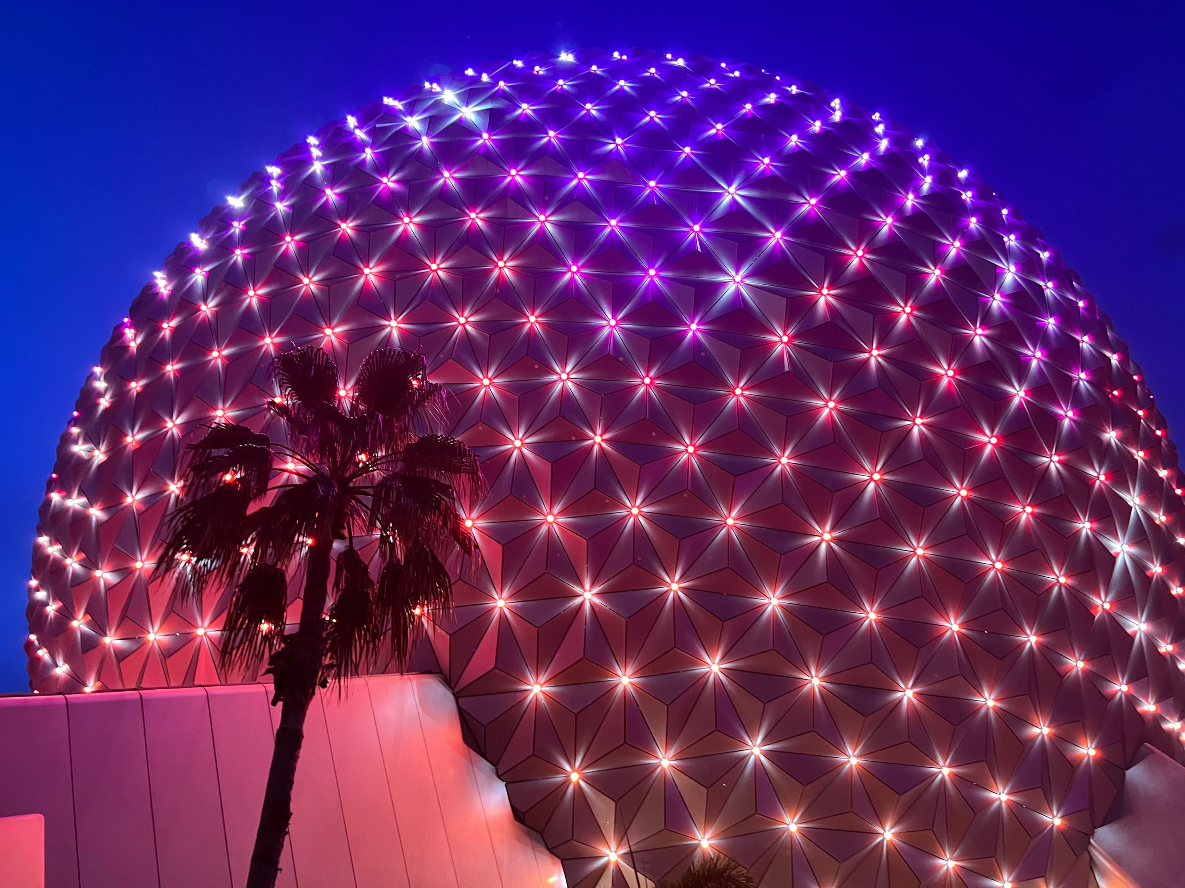 Spaceship Earth lit up after dark.