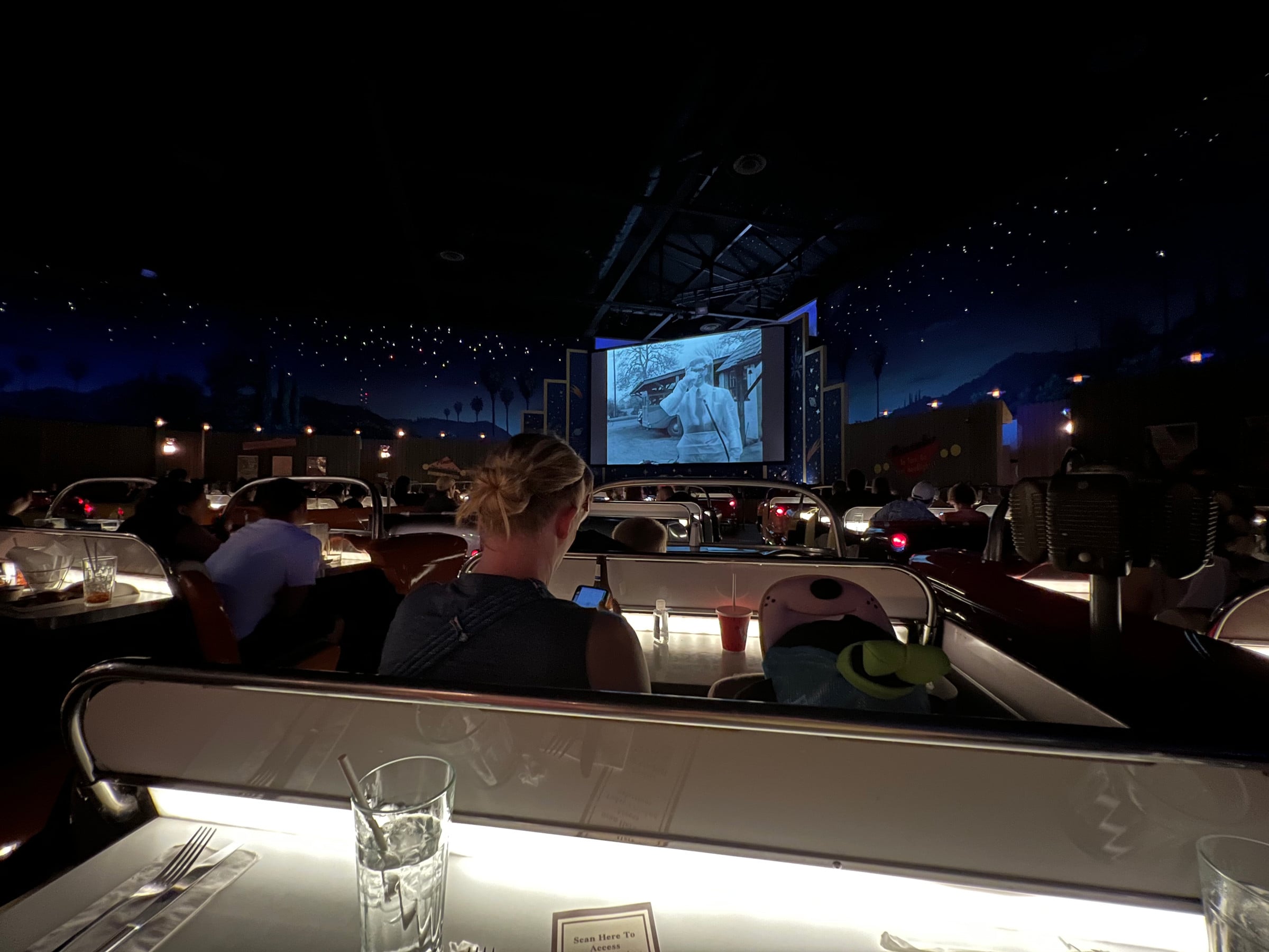The screen and car-shaped booths at Sci-Fi Dine-In.