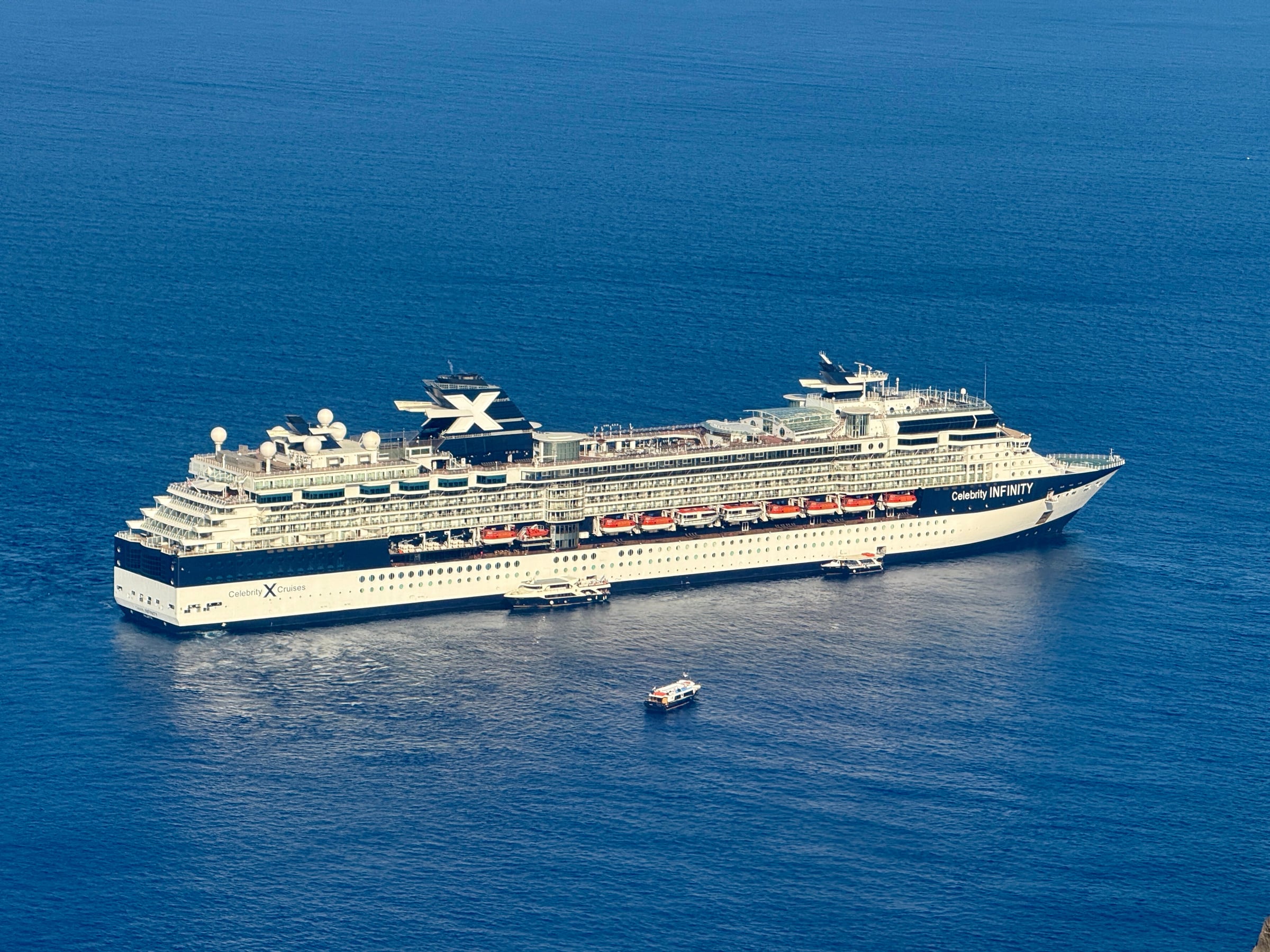 Celebrity Infinity below the cliffs of Santorini.