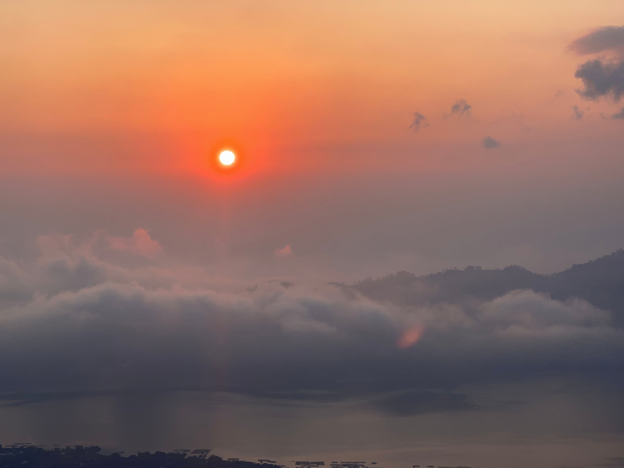 The sun clearing the cloud.