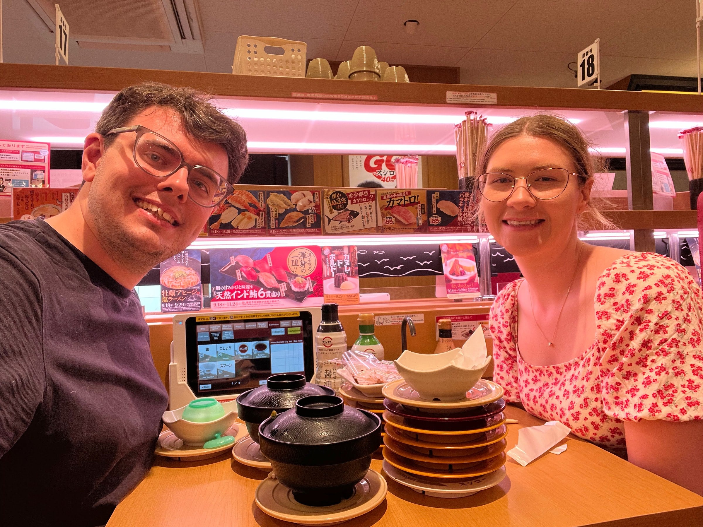 Sushi, with a growing stack of plates.