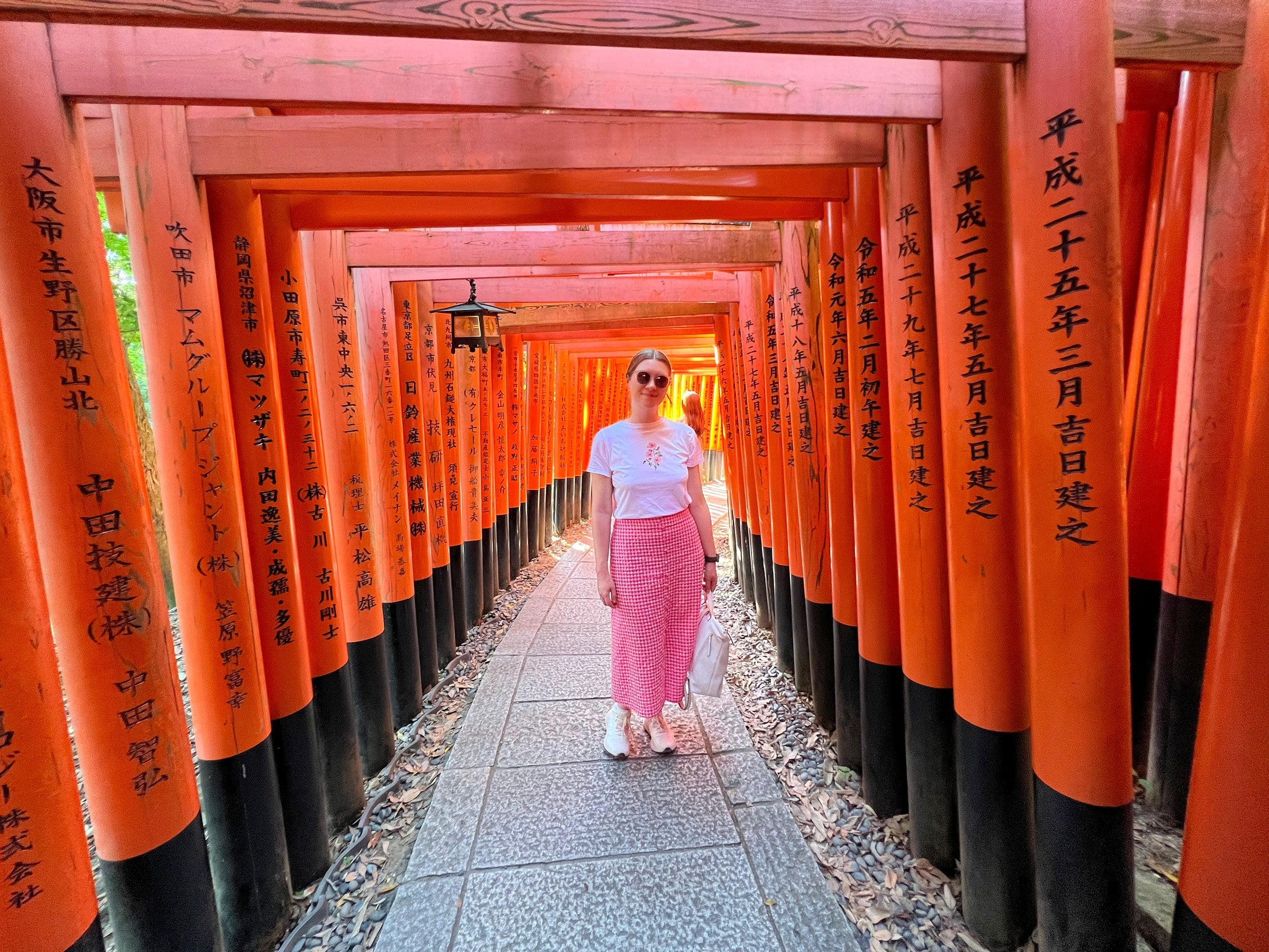 Lucy beneath the torii gates at Fushimi Inari.