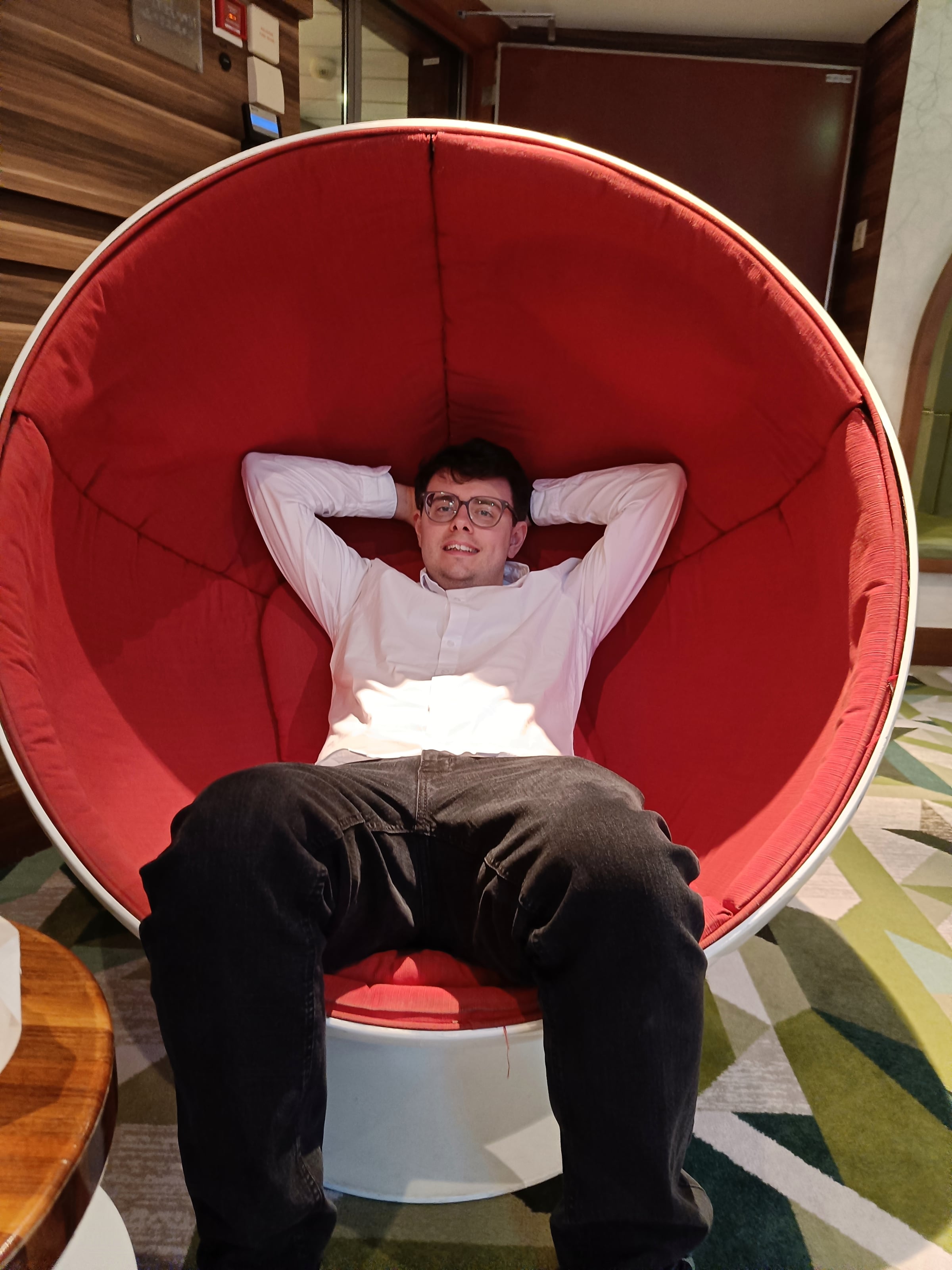 Trying out the large red chair onboard.