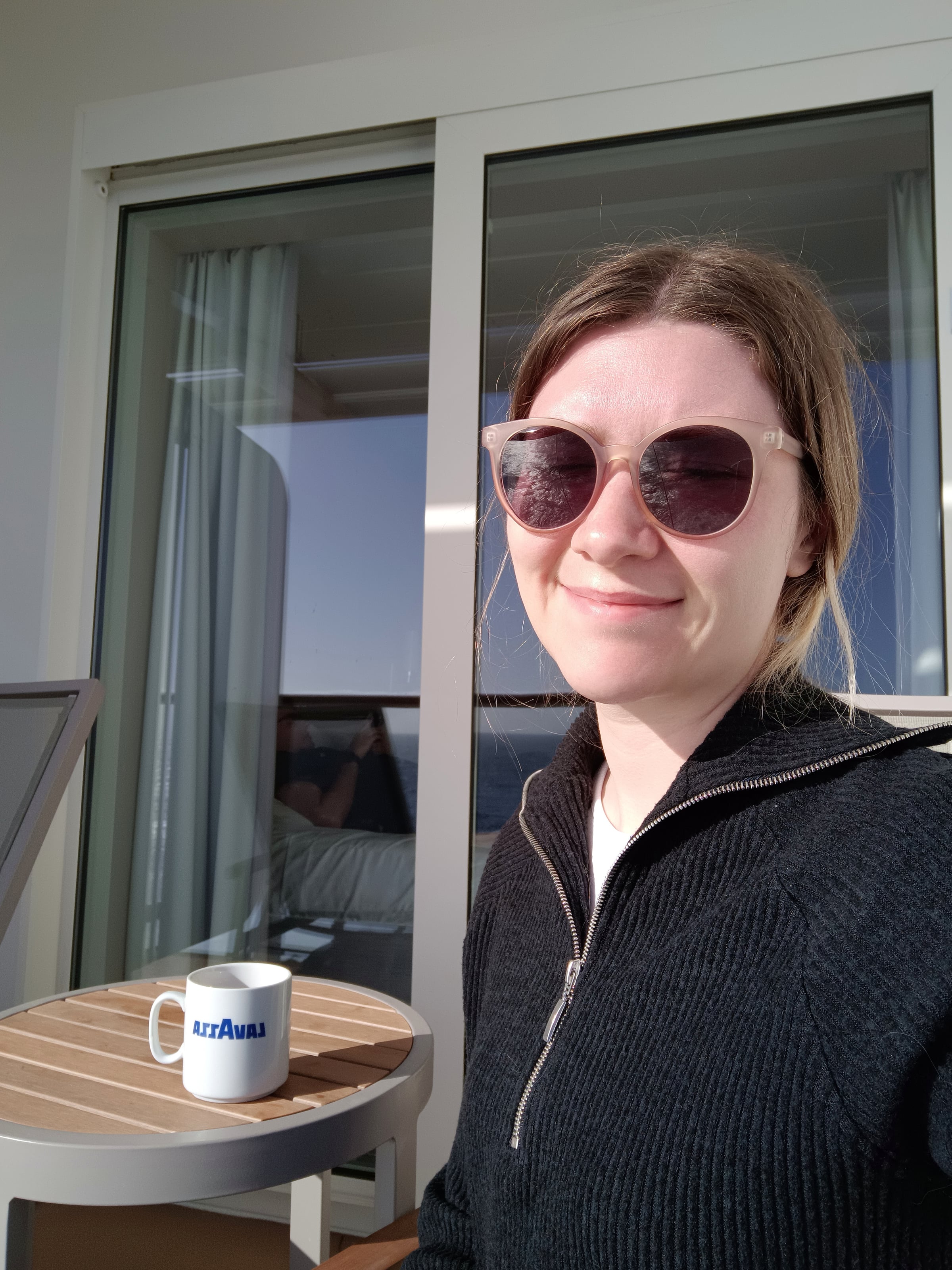 Lucy enjoying a drink on our balcony.
