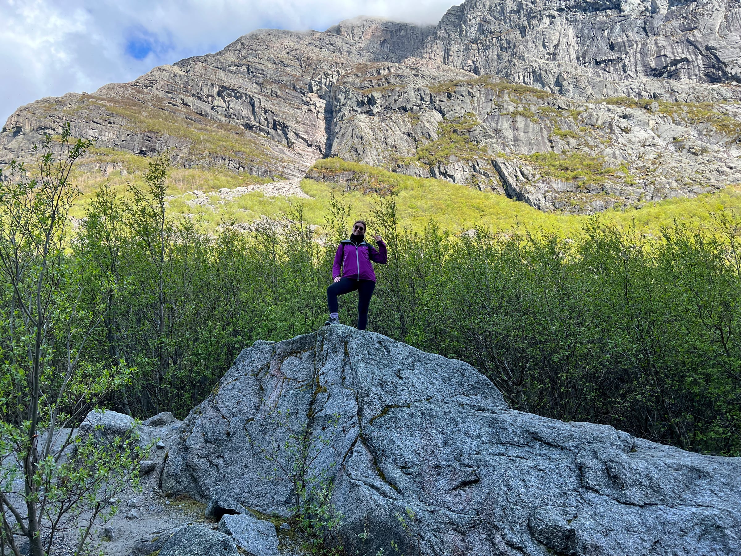 Lucy among the rocks and greenery in the Briksdal valley.